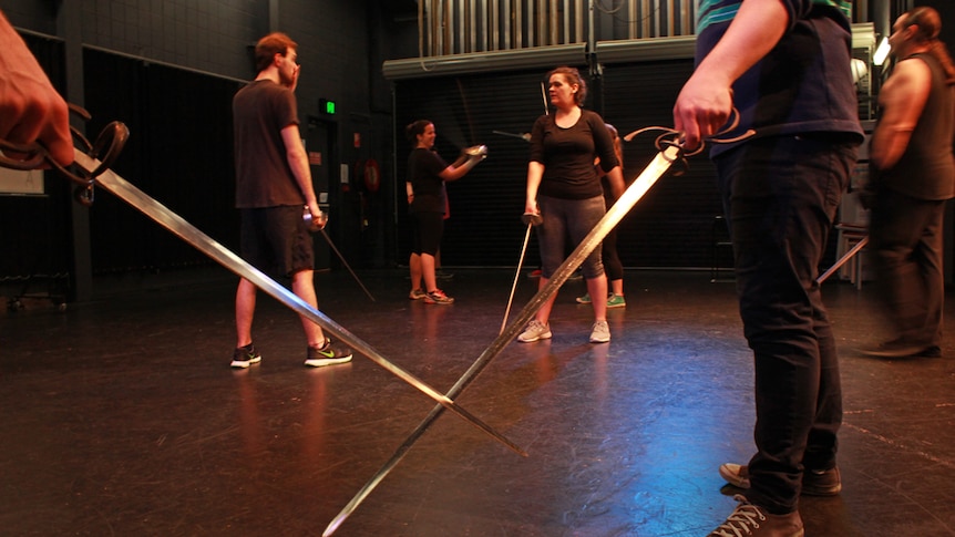 students sword fighting