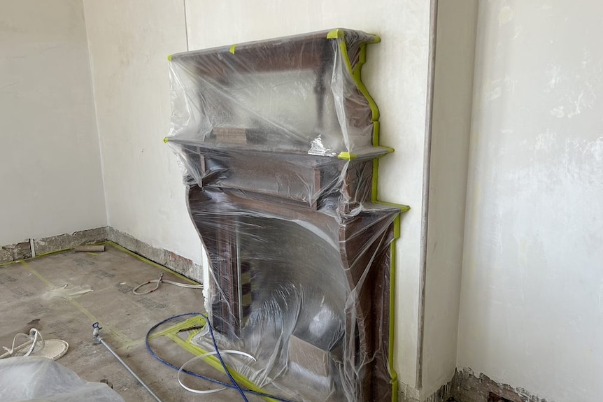 An image of plastic wrapping protecting a heritage listed fireplace in Lamb House