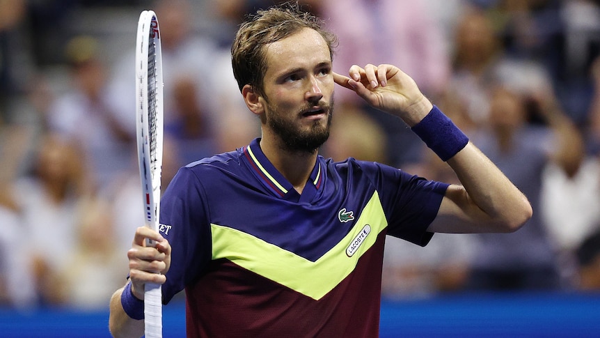 Daniil Medvedev puts a finger to his ear during US Open semifinal.