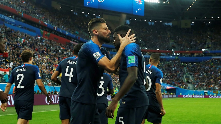 Olivier Giroud kisses Samuel Umtiti after scoring against Belgium