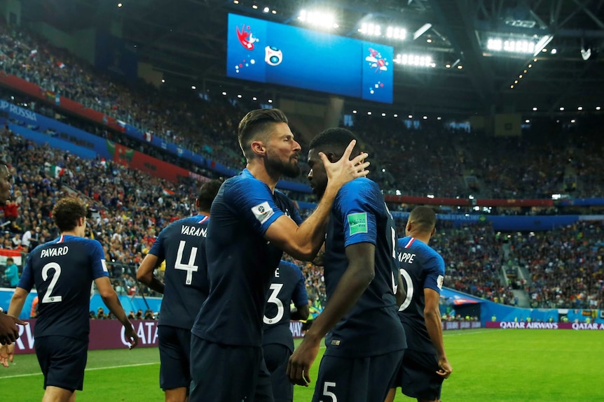 Olivier Giroud kisses Samuel Umtiti after scoring against Belgium