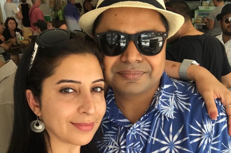 Shivani Sharma has her hand around her husband Vibhav's neck as the pose.