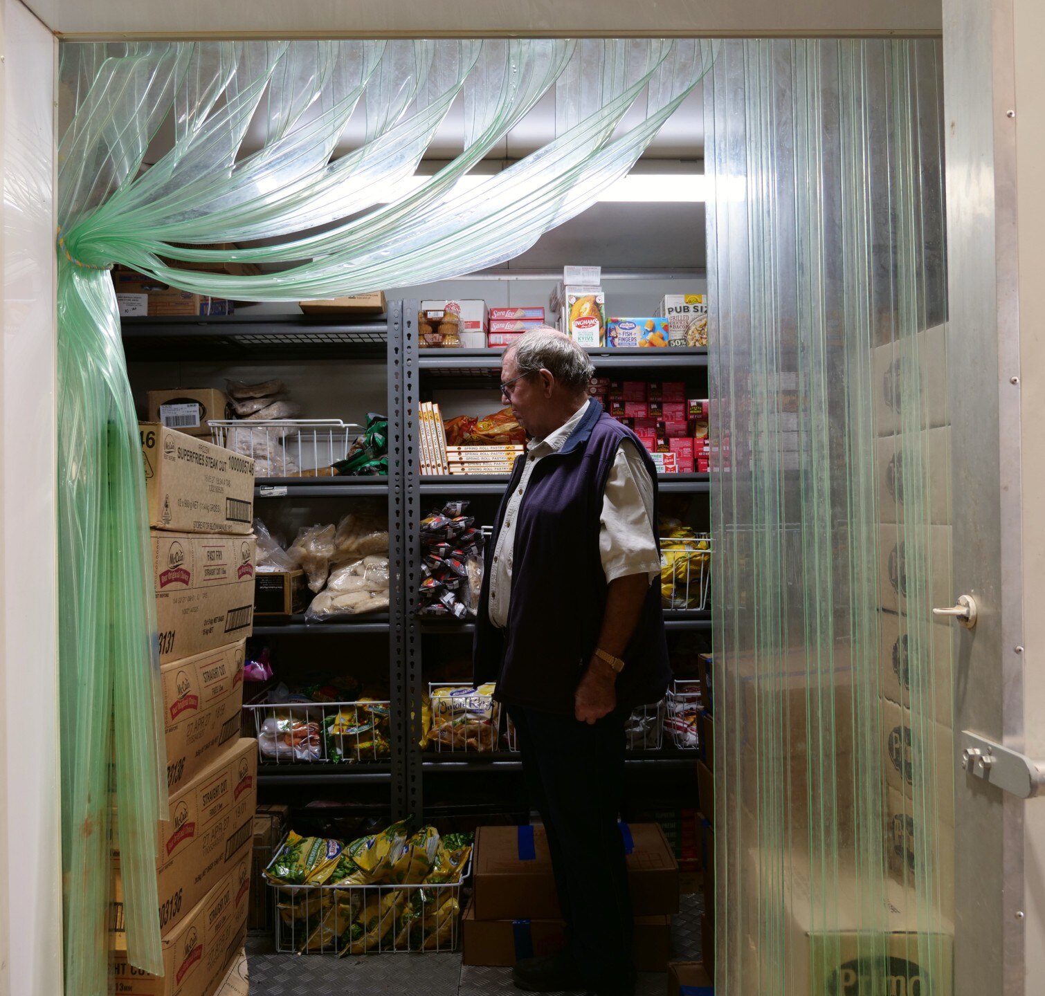 Man in a back storage freezer.