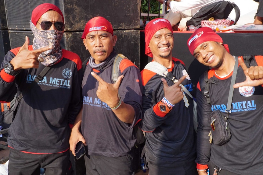 A group of men in bandanas pose for the camera