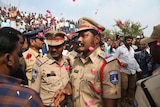 Citizens throw flower petals o Indian policemen.