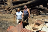Marysville residents Judy and Kevin Purtzel survey what is left of their property.
