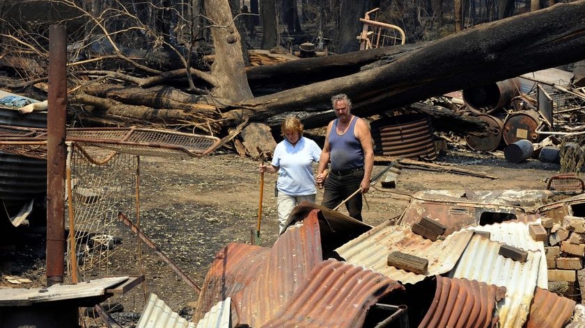 Judy and Kevin Purtzel survey bushfire damage to their property