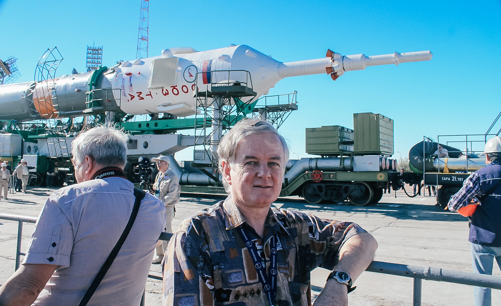 a man stands in front of a rocket