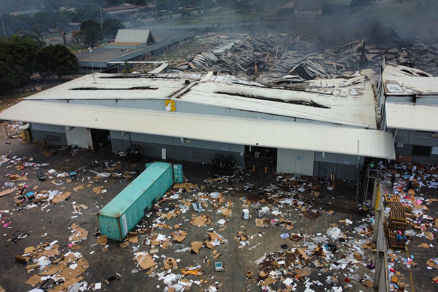 A birdseye view of destruction of a building with debris covering the street outside.