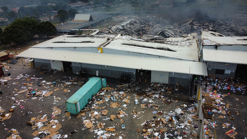 A birdseye view of destruction of a building with debris covering the street outside.