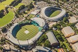 An aerial photo of the SCG and Sydney Football Stadium with the city skyline in the background.