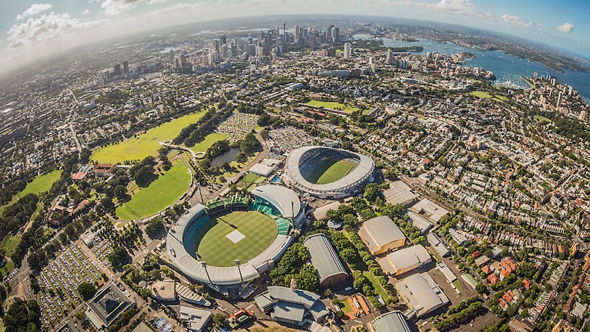 An aerial photo of the SCG and Sydney Football Stadium with the city skyline in the background.