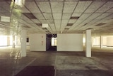 An abandoned office space that has been left to decay looks more like a car park than a place where people once worked.