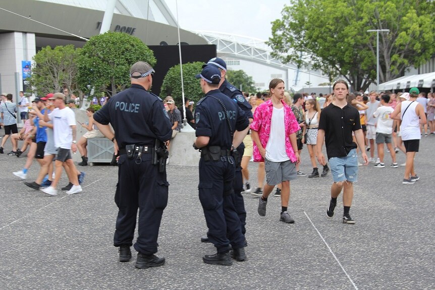 Police at the Rolling Loud festival surrounded by festival-goers.