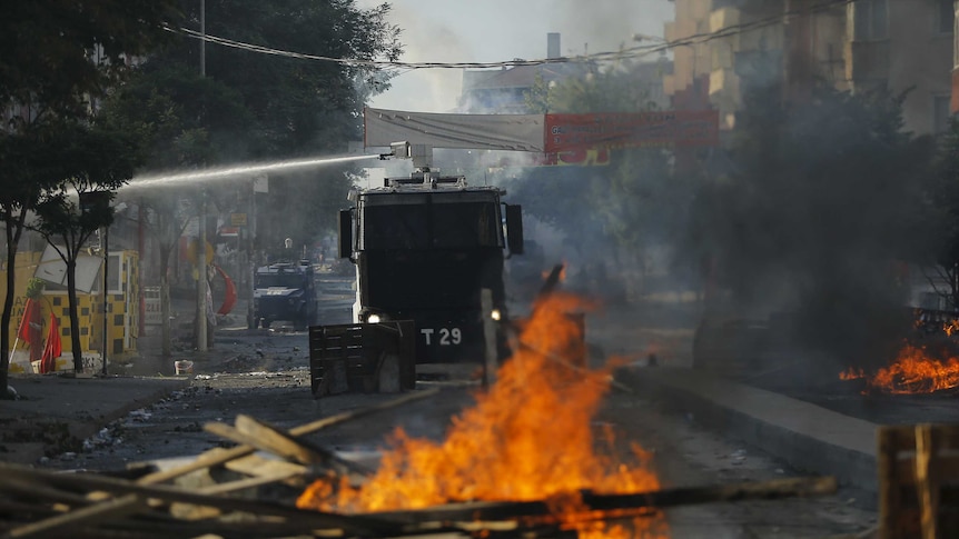 Turkish police use water cannon to disperse demonstrators during a funeral in Istanbul