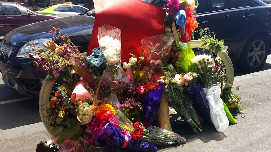 A bike is covered in flowers in memory of cyclist Alberto Paulon