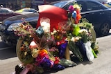 A bike is covered in flowers in memory of cyclist Alberto Paulon