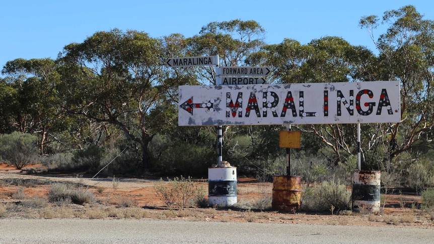 A sign on the side of the road indicating the way to Maralinga.