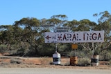 A sign on the side of the road indicating the way to Maralinga.