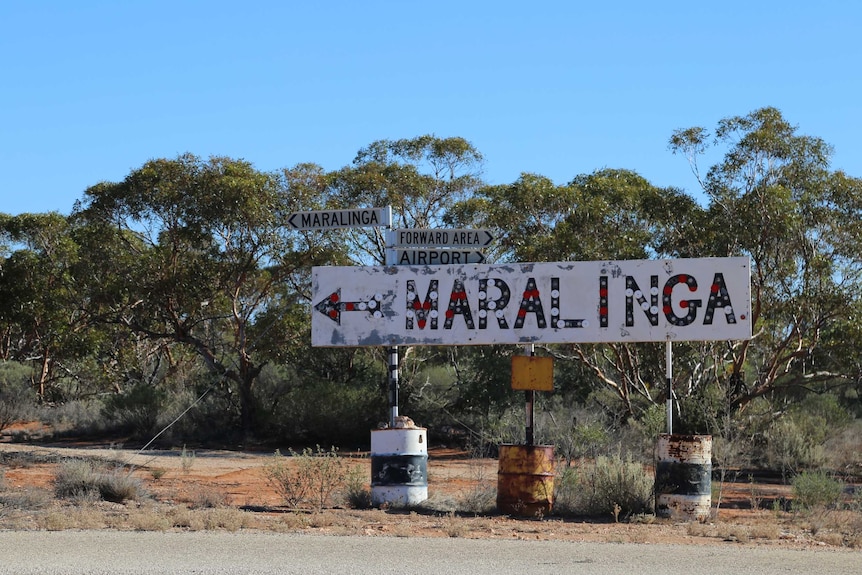 A sign on the side of the road indicating the way to Maralinga.