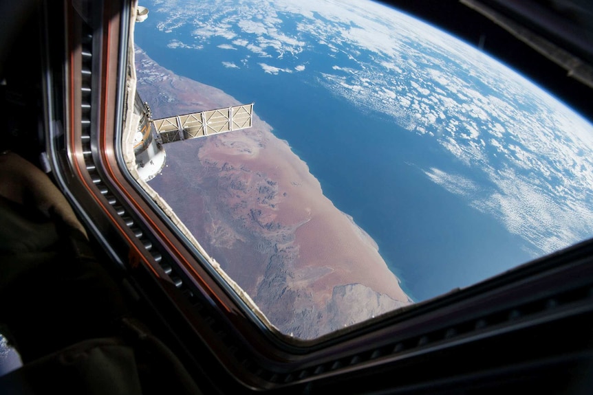 Earth seen through the window of the Space Station