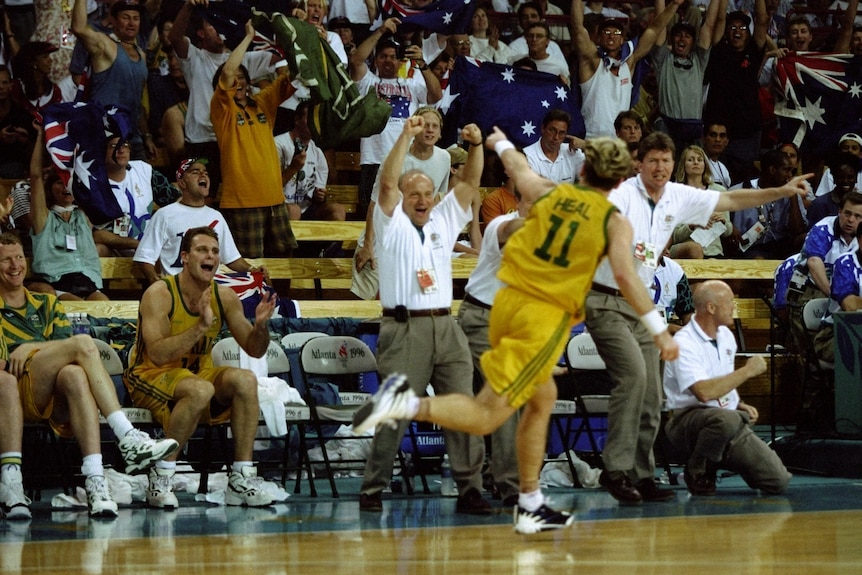 Shane Heal, seen from behind, points to the Boombers' bench and crowd during a basketball game at the 1996 Atlanta Olympics.