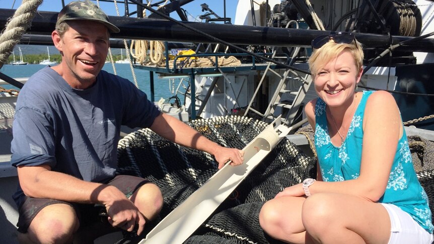 Skipper Brad Allen and NPF industry officer Adrianne Laird with one of the bycatch reduction devices being trialled this season