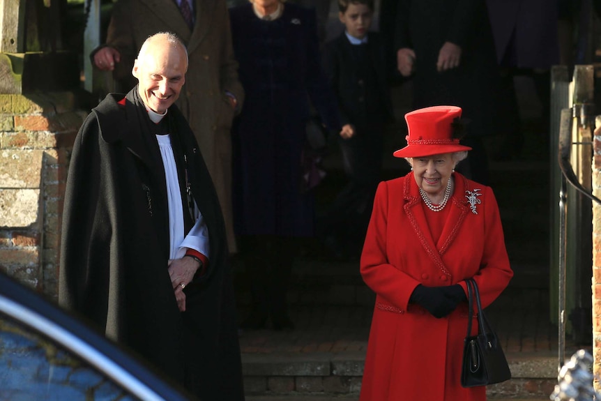 Britain's Queen Elizabeth II waits for her car at the front of the church.