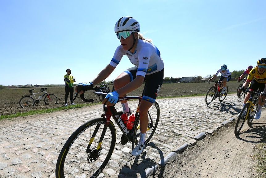 Ellen van Dijk rides her bike on cobbles