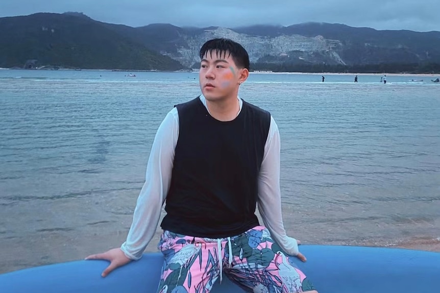 a young man sitting in a canoe