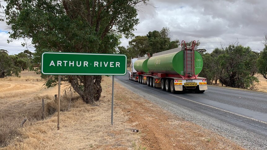 A road sign saying "Arthur River" on the side of a country highway.