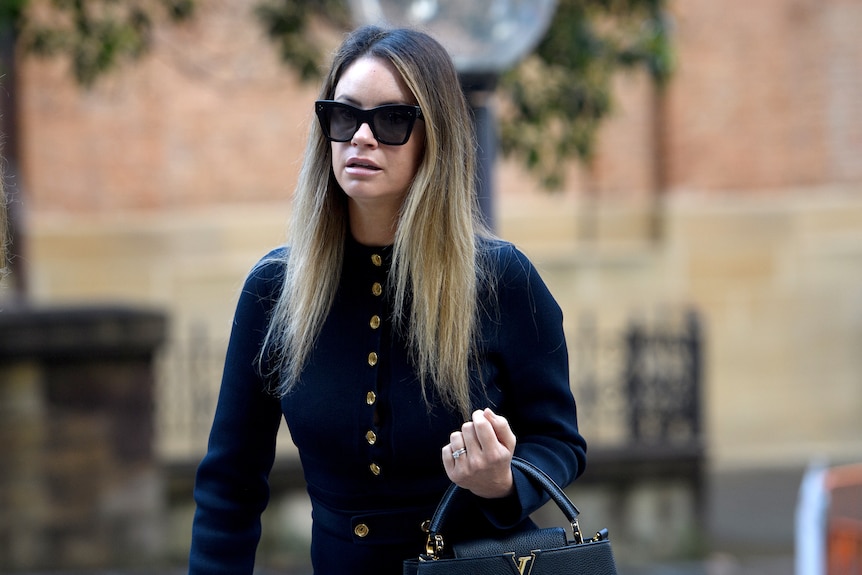 a woman wearing dark glasses