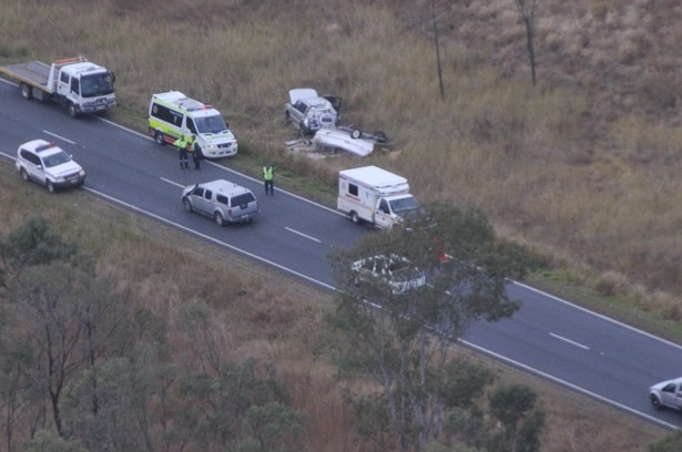Authorities at the site of a four-wheel-drive vehicle rollover on the Bruce Highway north of Marlborough in central Qld
