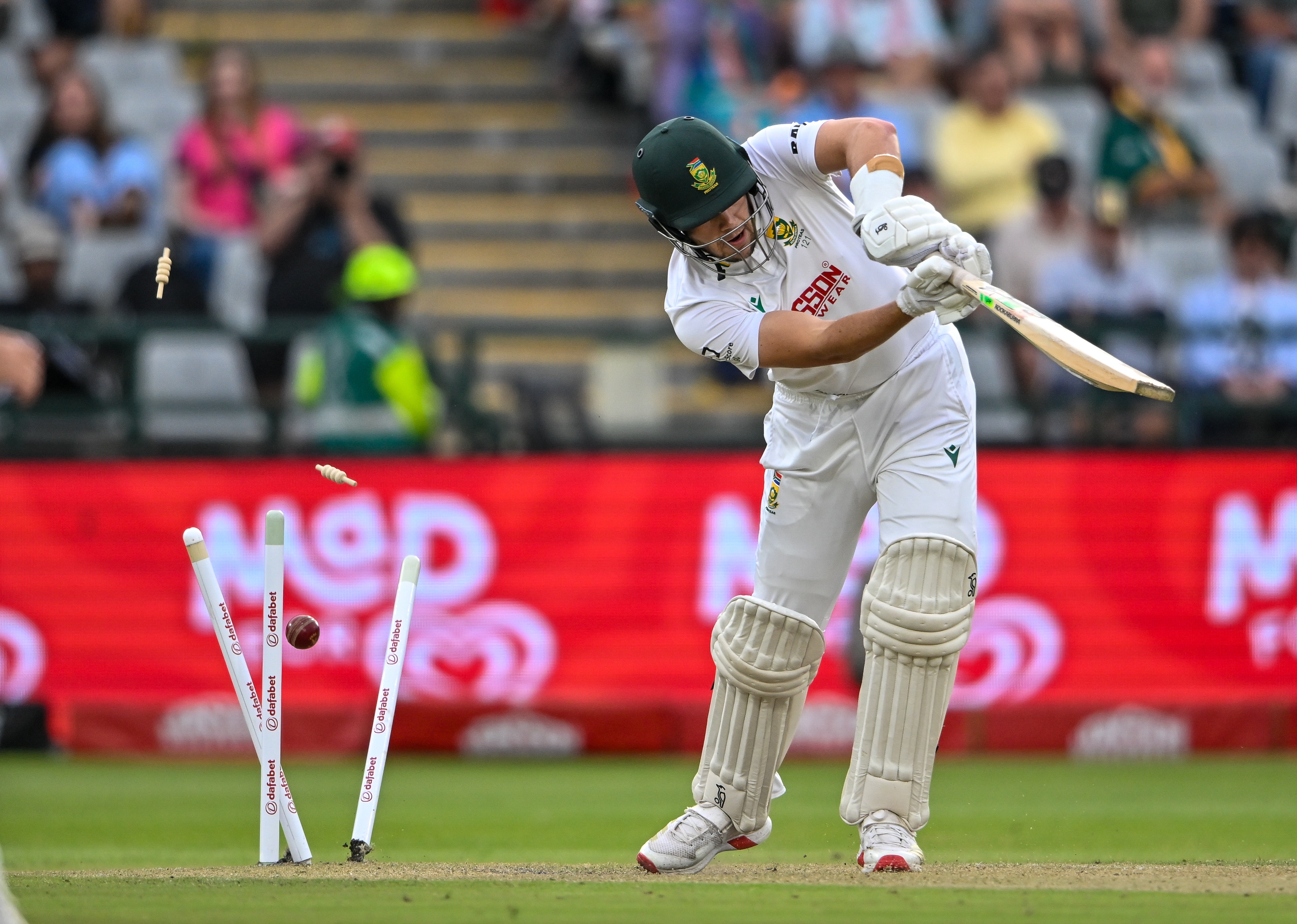 A cricket batter is bowled while playing a shot