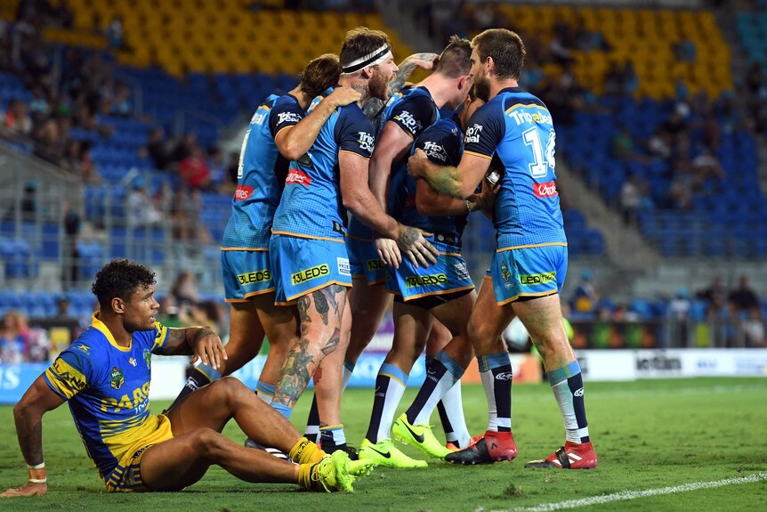 Titans celebrate a try against the despondent Eels