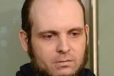 A close-up photograph of Joshua Boyle shows him looking pale whilst speaking to the media.