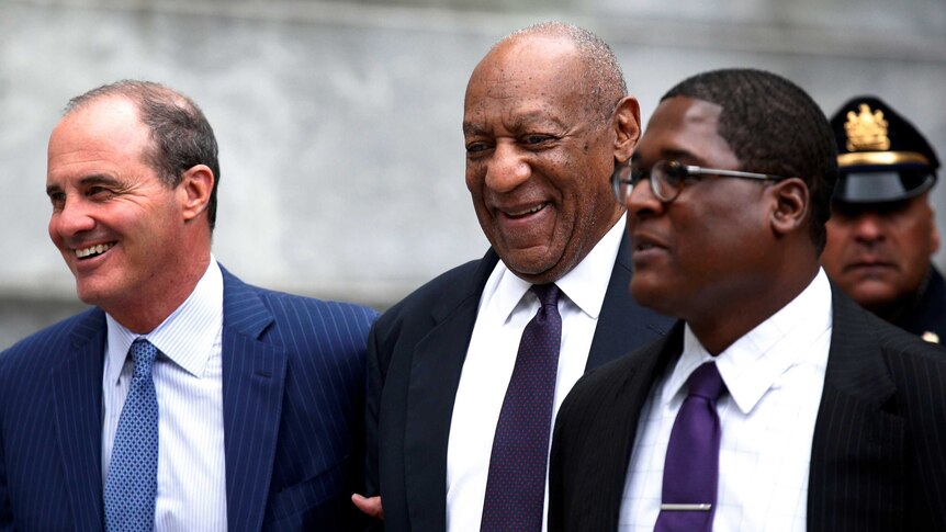 Bill Cosby leaves court with his spokesman Andrew Wyatt (R) and lawyer Brian McMonagle.