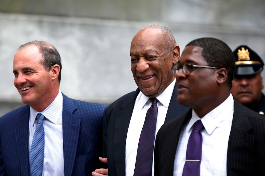 Bill Cosby leaves court with his spokesman Andrew Wyatt (R) and lawyer Brian McMonagle.