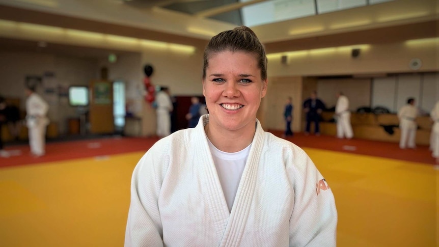 Judo coach Carla Johnson smiles at the camera.