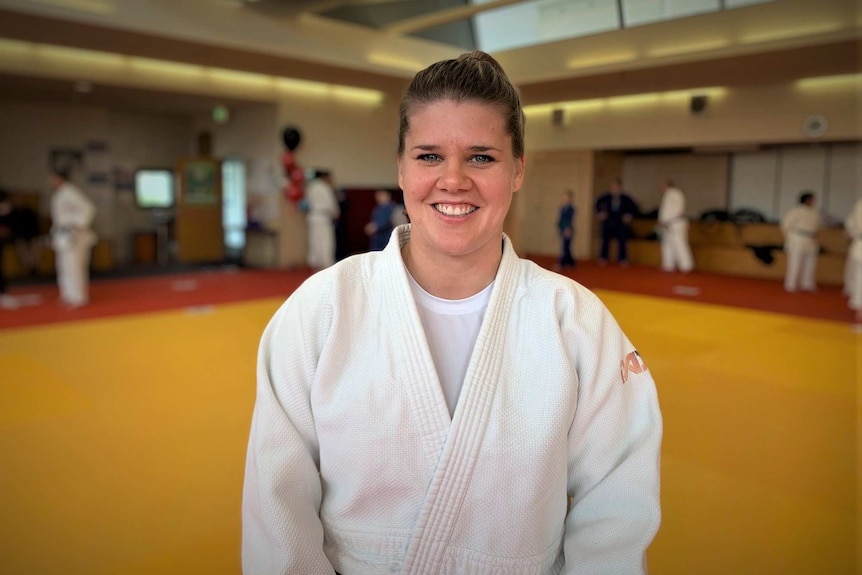 Judo coach Carla Johnson smiles at the camera.