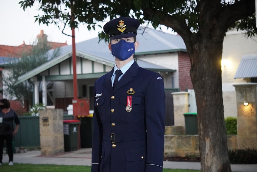 Max Murphy in full uniform outside the front of a house.