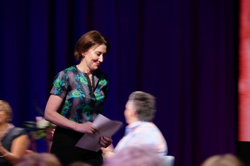 With paper in hand, Virginia Trioli walks to deliver a speech