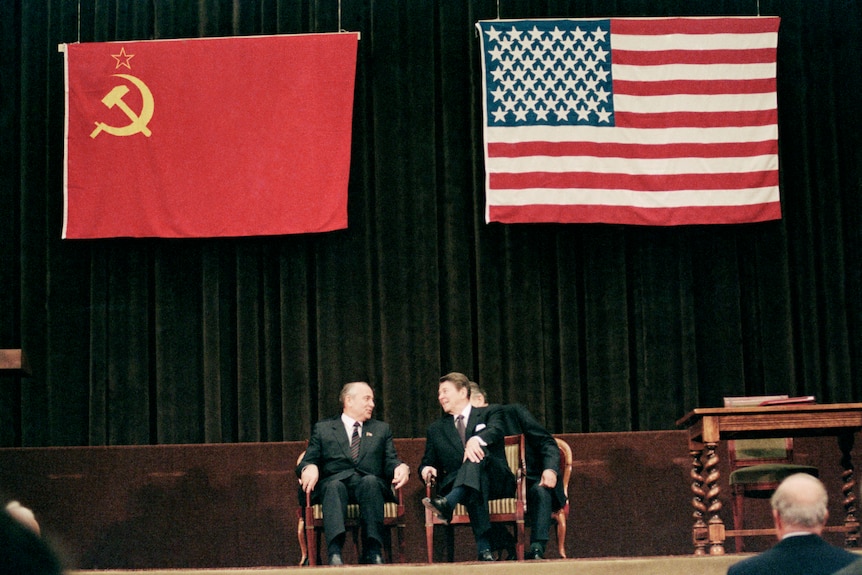 Mikhail Gorbachev and US president Ronald Reagan smile during concluding summit ceremony.