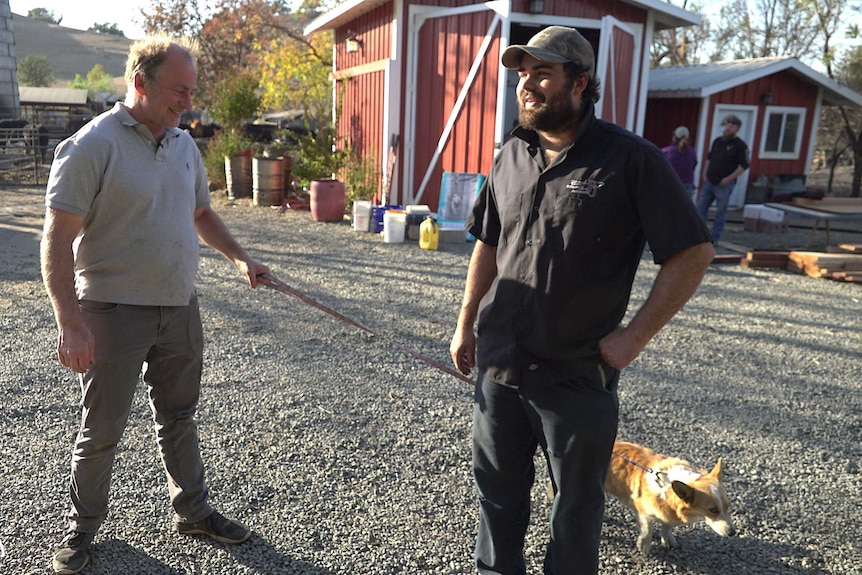 Eric smiles and chats to his son Logan while walking his dog.