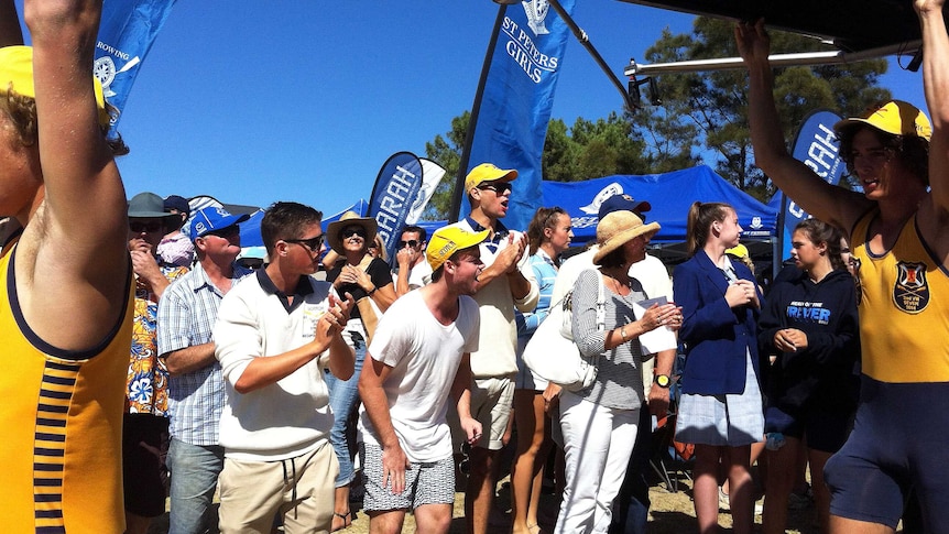 The crowd cheers on Scotch College rowers