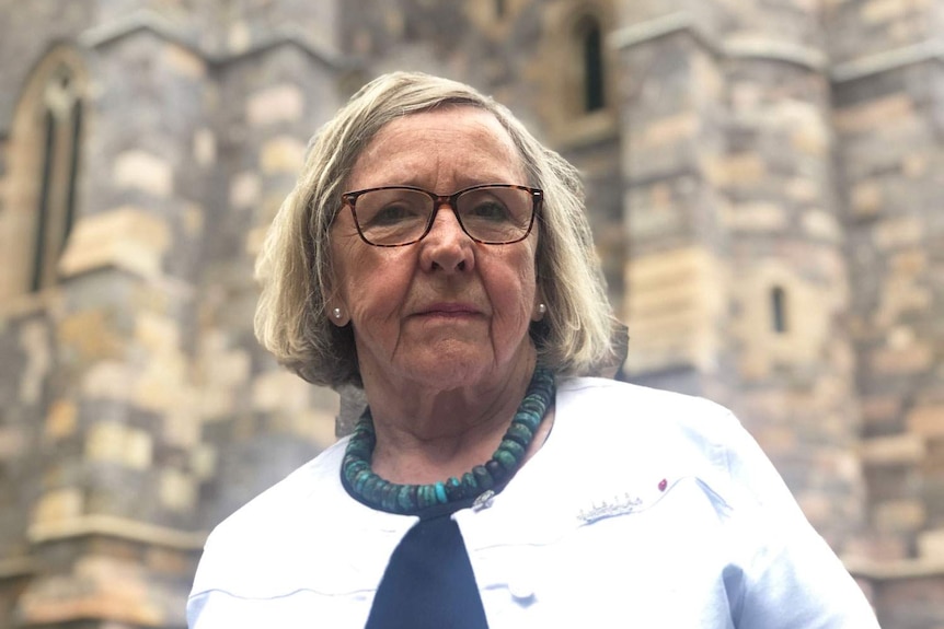 Abuse survivor Beth Heinrich stands outside a church in Brisbane.