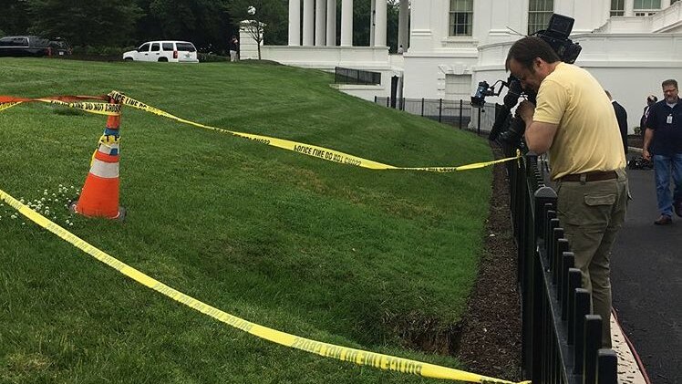 Cameraman films sinkhole on North Lawn outside the White House.