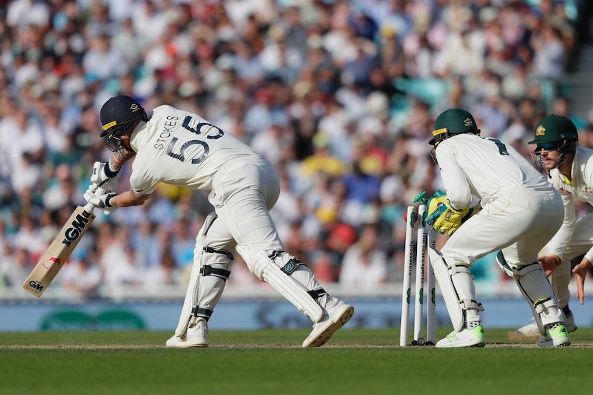 The stumps of England batsman Ben Stokes are disturbed by the ball, as seen from behind.