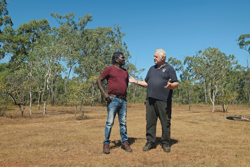 Gumatj CEO Klaus Helms and educator Murphy Yunupingu stand talking at the Garma Festival site.