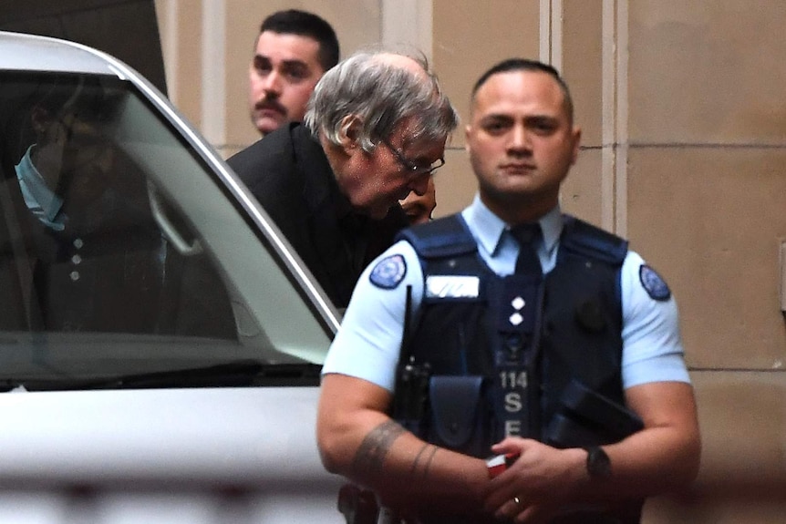George Pell as he is escorted from a prison van into the Supreme Court of Victoria.